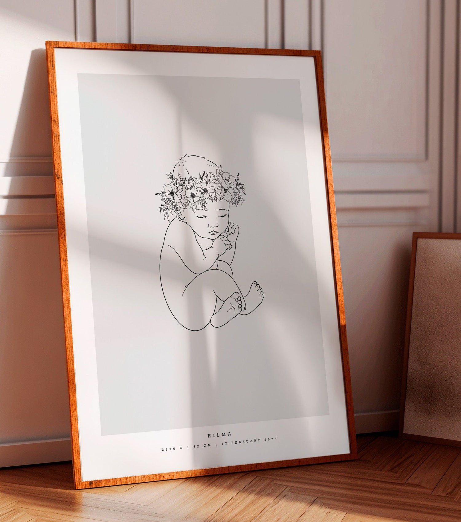 Baby with a flower crown on the head, illustrated on a minimalist birth poster with name and birth details.