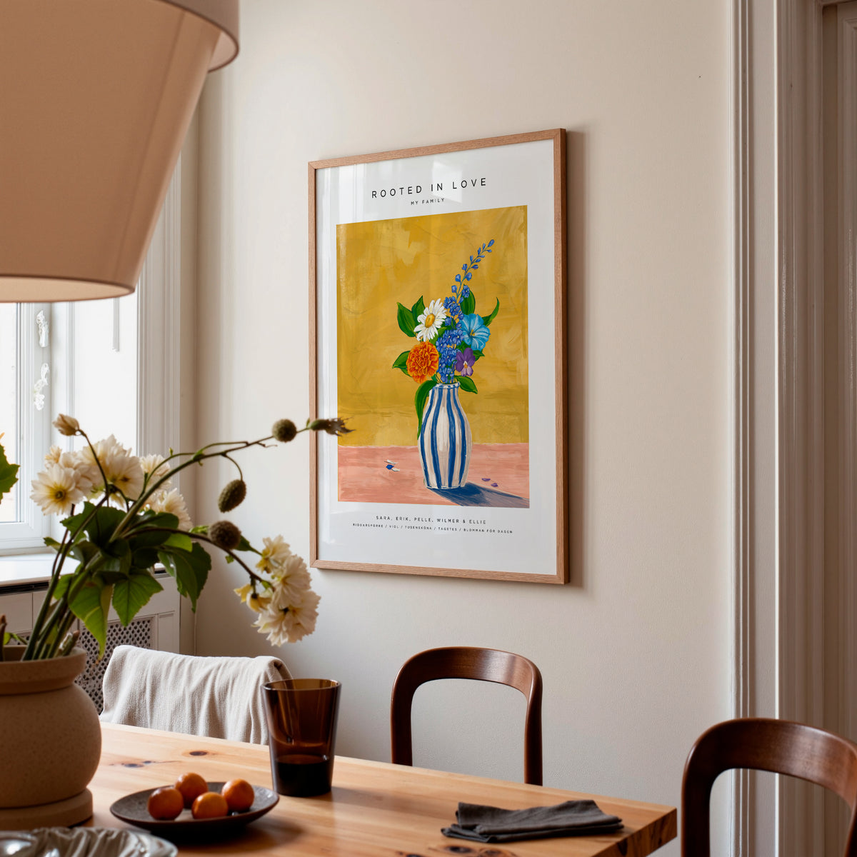 Rooted in Love family vase in an oak frame above a dining table