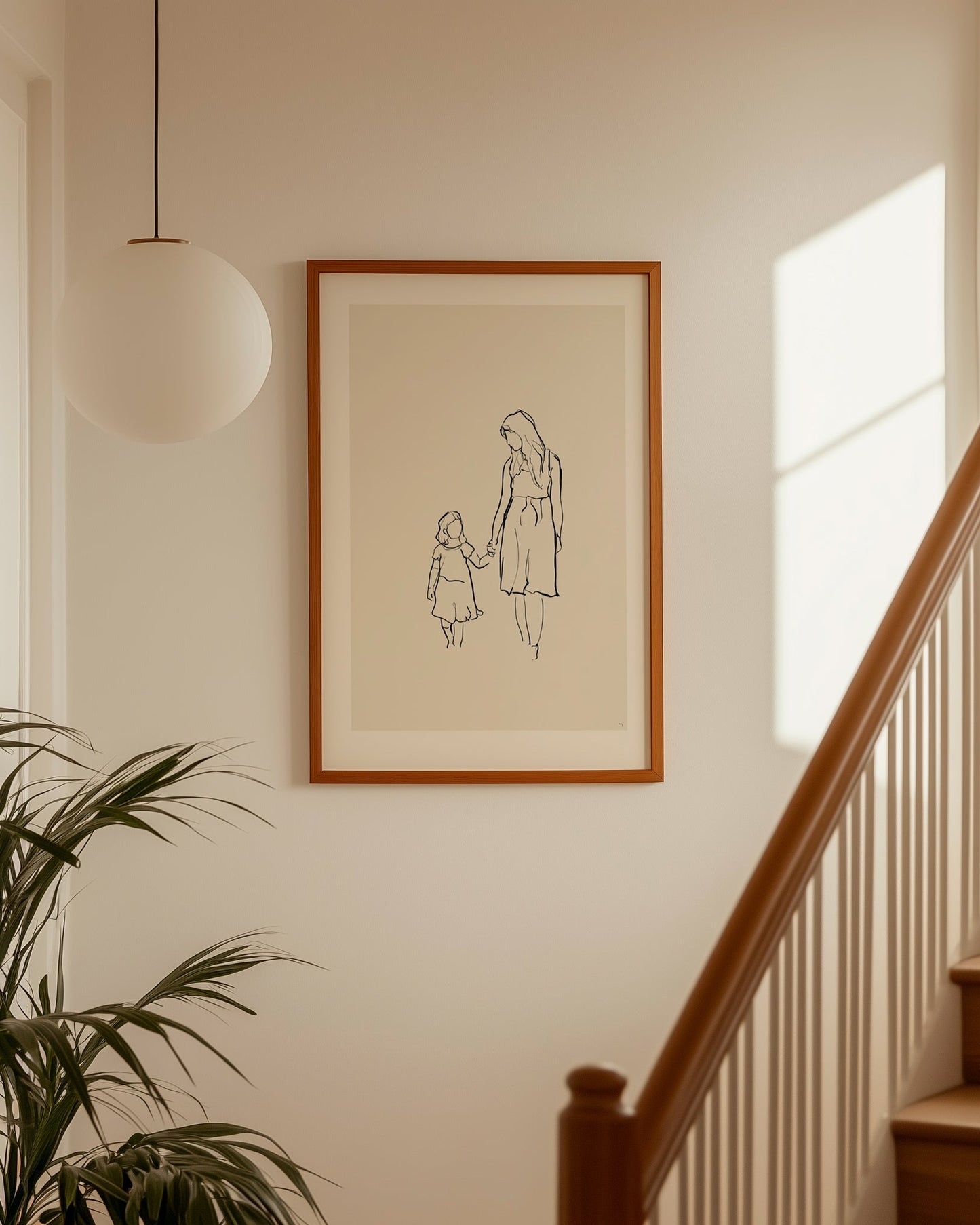 Minimalist arty line art portrait of mother and daughter displayed as wall art in a modern neutral home interior